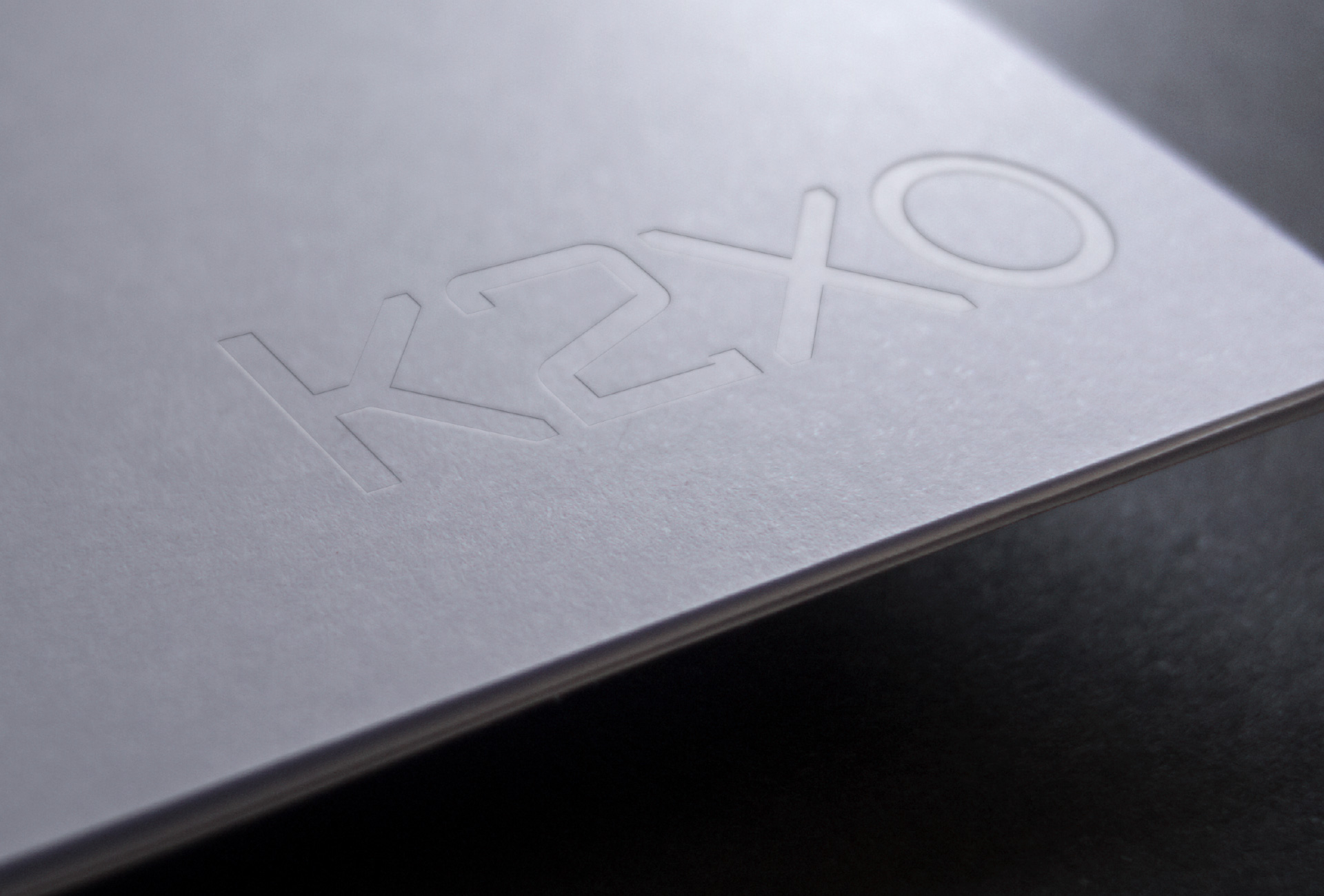 Embossed K2XO logo on white paper