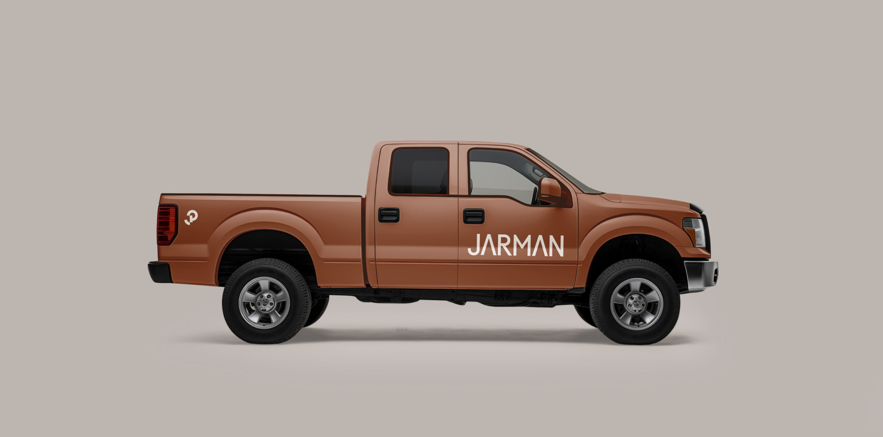 Jarman Professional branded construction pickup truck featuring the wordmark and geometric monogram.